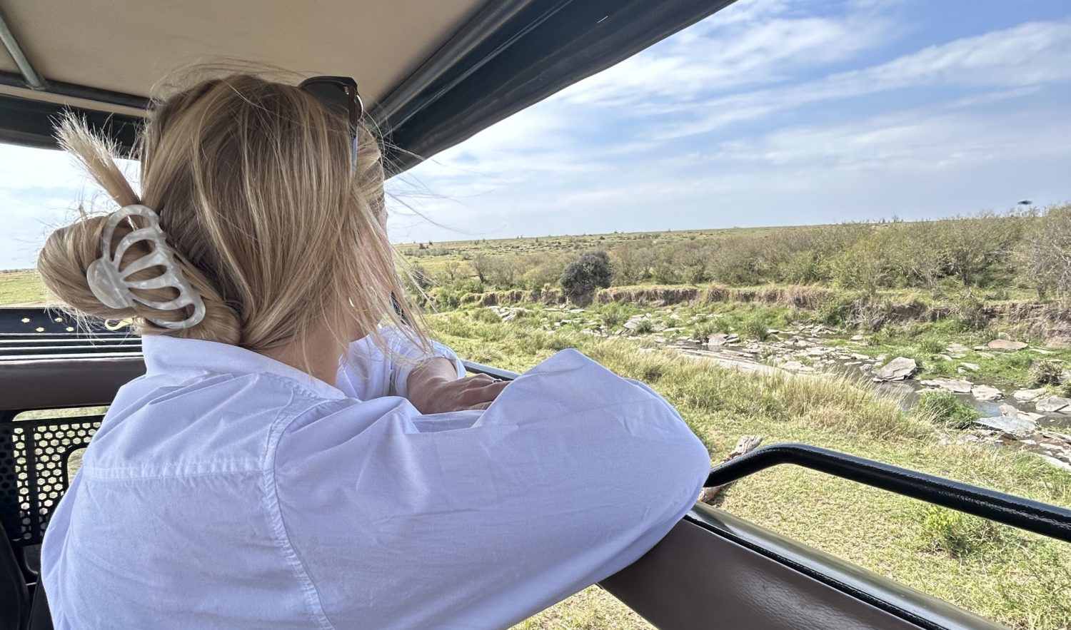 woman looking out of a safari vehicle